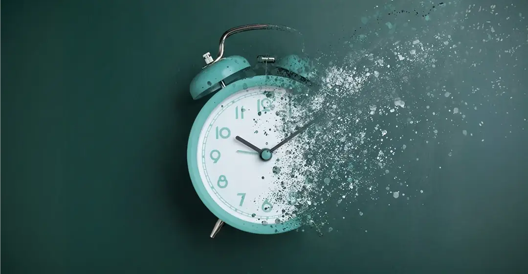 Abstract image of an alarm clock partially dissolving into particles representing the contrast between continuous compliance monitoring and point in time audits